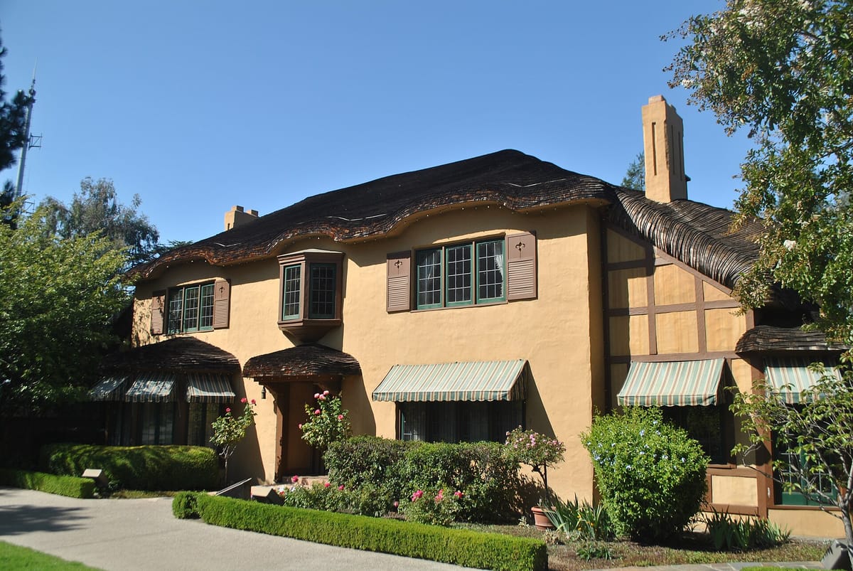 The Ainsley House behind its clipped hedges and garden beds