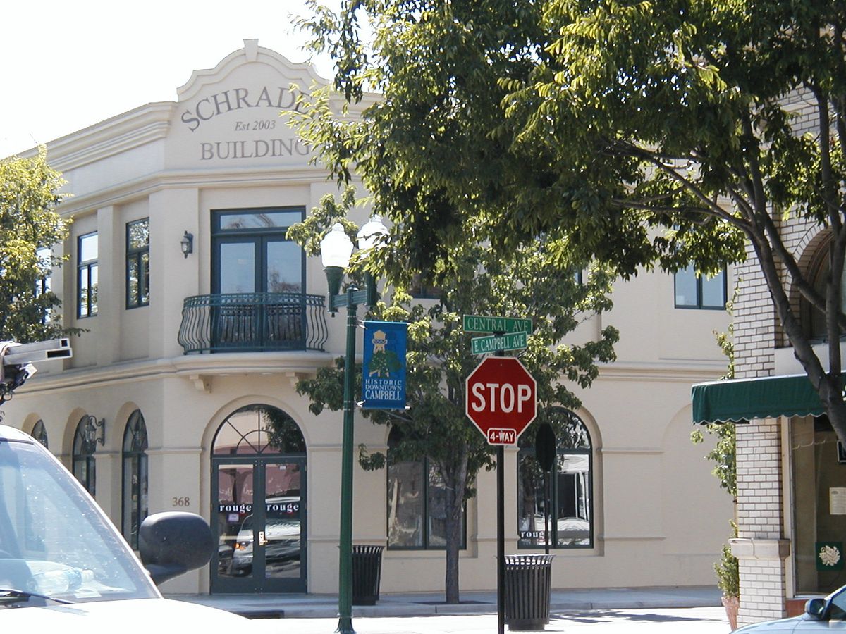 A two-story historic building on East Campbell Avenue under the trees