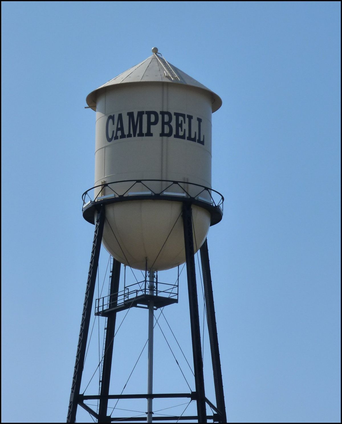 The Campbell water tower, its tank lettered CAMPBELL, against a blue sky